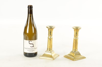 Lot 645 - A PAIR OF GEORGE III BRASS CANDLESTICKS