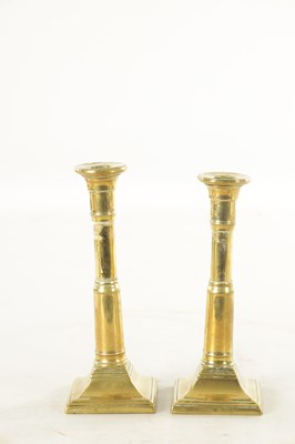 Lot 645 - A PAIR OF GEORGE III BRASS CANDLESTICKS