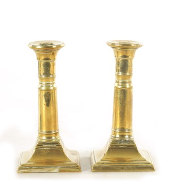 Lot 645 - A PAIR OF GEORGE III BRASS CANDLESTICKS