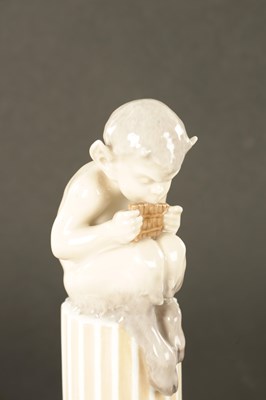 Lot 36 - AN EARLY 20TH CENTURY ROYAL COPENHAGEN FIGURE MODELLED AS FAUN ON COLUMNS WITH LIZARD