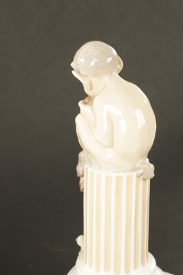 Lot 36 - AN EARLY 20TH CENTURY ROYAL COPENHAGEN FIGURE MODELLED AS FAUN ON COLUMNS WITH LIZARD