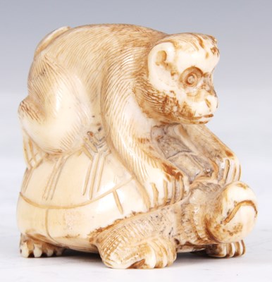 Lot 109 - A JAPANESE IVORY NETSUKE of a monkey sat on a...