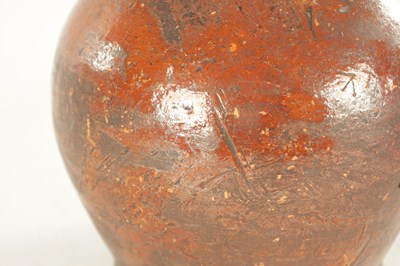 Lot 76 - AN EARLY BROWN GLAZED TERRACOTTA WINE JAR