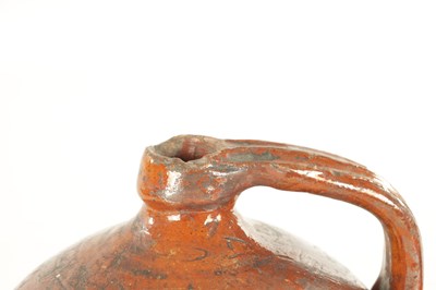 Lot 76 - AN EARLY BROWN GLAZED TERRACOTTA WINE JAR
