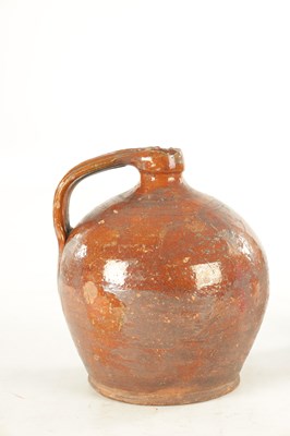 Lot 76 - AN EARLY BROWN GLAZED TERRACOTTA WINE JAR