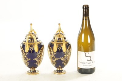 Lot 59 - A PAIR OF 19TH CENTURY VIENNA PORCELAIN RICHLY GILT AND ROYAL BLUE TWO HANDLED COVERED VASES