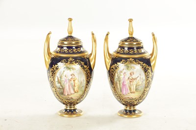 Lot 59 - A PAIR OF 19TH CENTURY VIENNA PORCELAIN RICHLY GILT AND ROYAL BLUE TWO HANDLED COVERED VASES