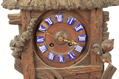 Lot 1079 - A LATE 19TH BLACK FOREST CARVED LINDEN WOOD MANTEL CLOCK