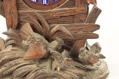 Lot 1079 - A LATE 19TH BLACK FOREST CARVED LINDEN WOOD MANTEL CLOCK