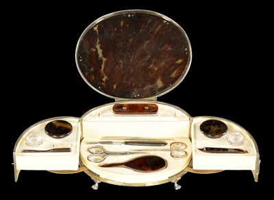 Lot 471 - A LARGE EDWARDIAN OVAL SILVER MOUNTED TORTOISESHELL MANICURE SET
