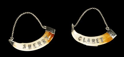 Lot 434 - A PAIR OF SILVER MOUNTED BOAR'S TEETH WINE LABELS