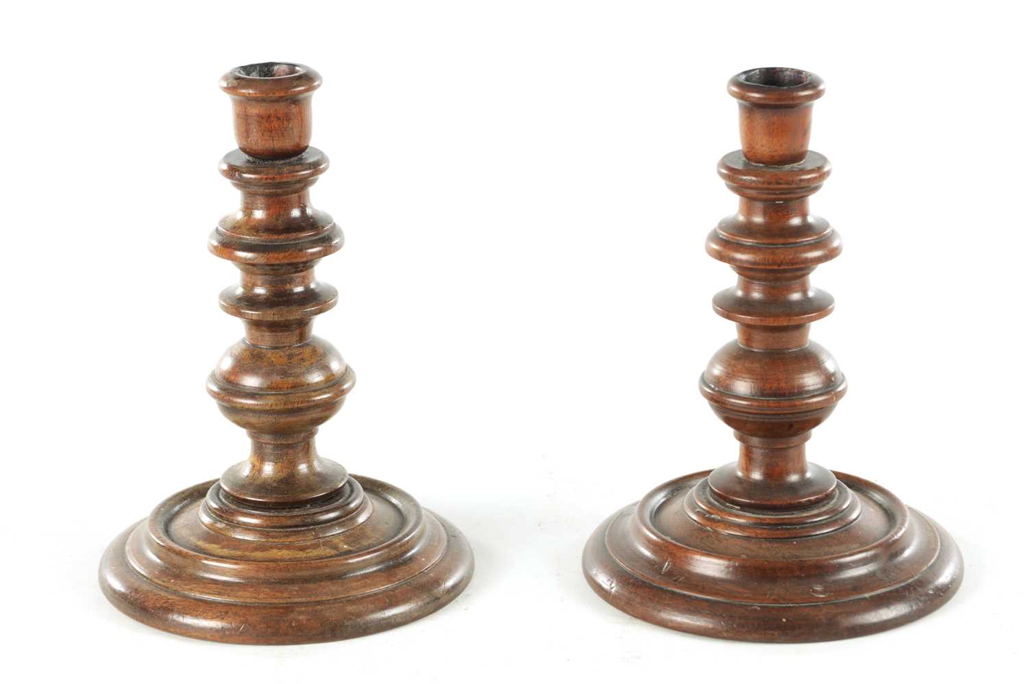 Lot 913 - A PAIR OF 19TH CENTURY TURNED WALNUT TREENWARE CANDLESTICKS