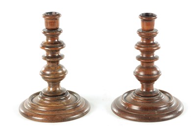 Lot 913 - A PAIR OF 19TH CENTURY TURNED WALNUT TREENWARE CANDLESTICKS