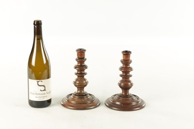 Lot 913 - A PAIR OF 19TH CENTURY TURNED WALNUT TREENWARE CANDLESTICKS