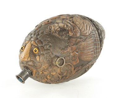 Lot 687 - AN EARLY 19TH CENTURY CARVED COCONUT BUGBEAR FLASK
