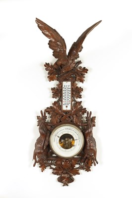 Lot 1028 - A LATE 19TH CENTURY BLACK FOREST CARVED BAROMETER