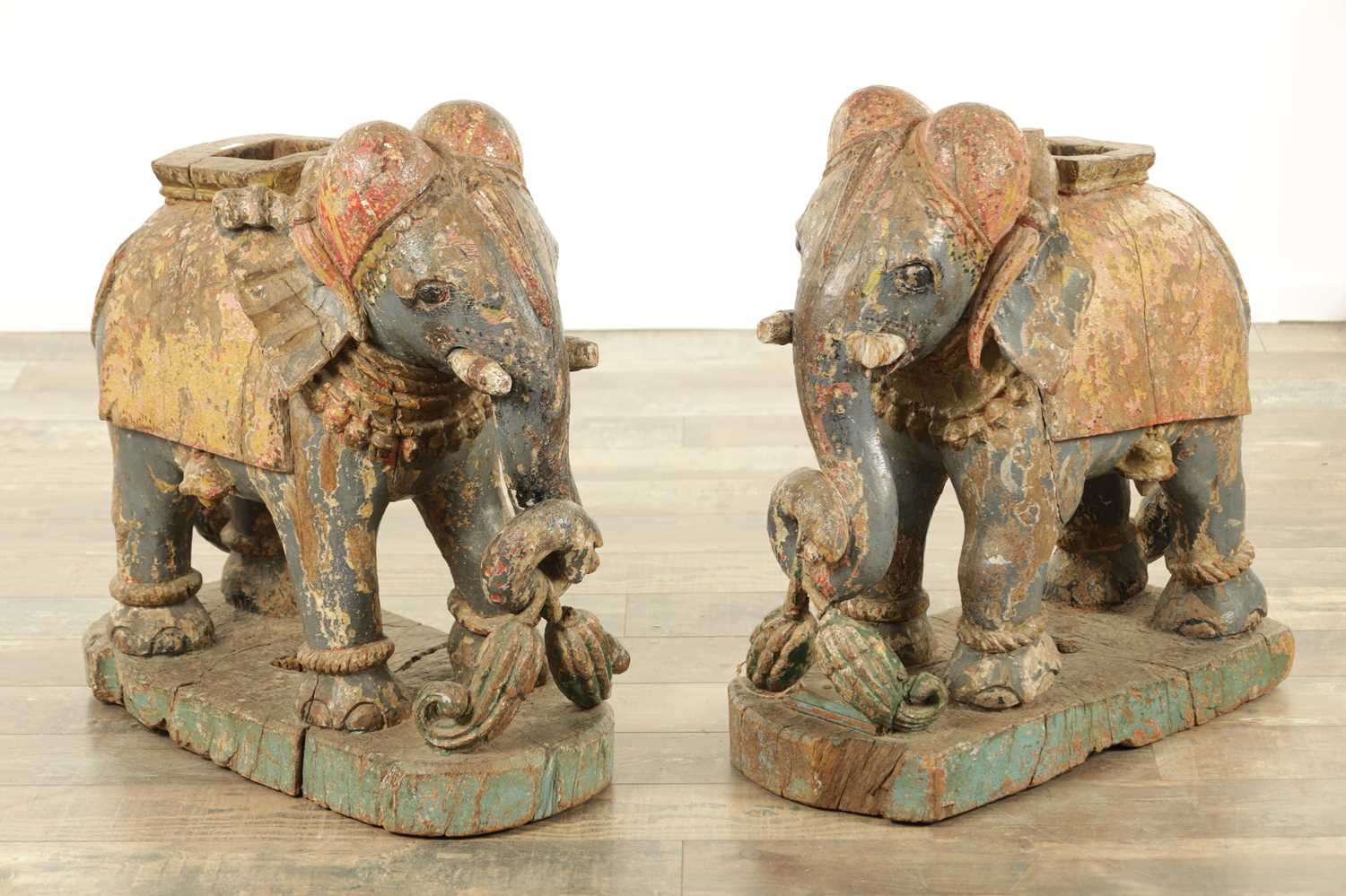 Lot 222 - A LARGE PAIR OF 19TH CENTURY INDIAN CARVED POLYCHROME PAINTED SCULPTURES OF ELEPHANTS