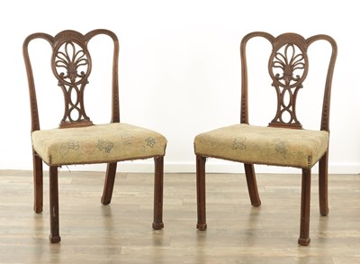Lot 1235 - AN UNUSUAL PAIR OF GEORGE III MAHOGANY SIDE CHAIRS IN THE MANNER OF THOMAS CHIPPENDALE