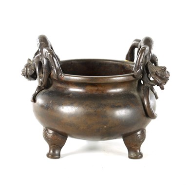 Lot 241 - A CHINESE PATINATED BRONZE CENSER WITH DRAGON HANDLES
