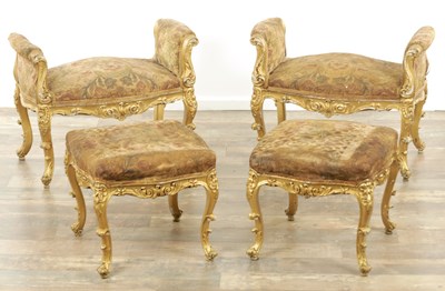 Lot 1305 - A SUITE OF FOUR CARVED GILTWOOD ROCOCO STYLE STOOLS