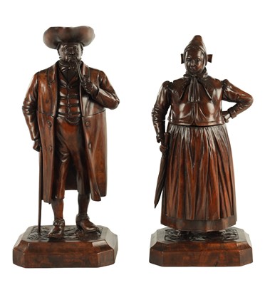 Lot 930 - A FINE PAIR OF 19TH CENTURY CARVED WALNUT BLACK FOREST TABACO JARS