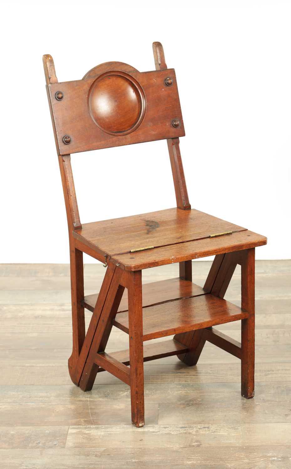 Lot 1347 - AN ARTS AND CRAFTS WALNUT METAMORPHIC LIBRARY CHAIR / STEPS