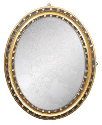 Lot 1310 - A 19TH CENTURY IRISH EBONISED AND GILT WOOD OVAL SHAPED HANGING MIRROR