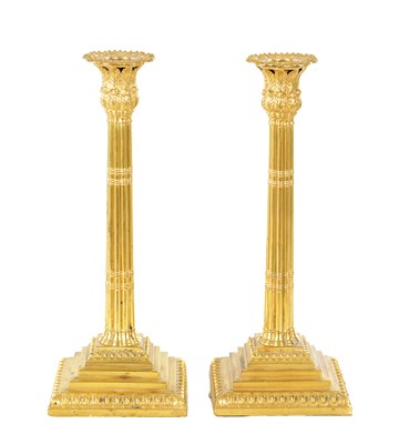 Lot 407 - A PAIR OF EARLY 19TH CENTURY CONTINENTAL GILT METAL TABLE CANDLESTICKS
