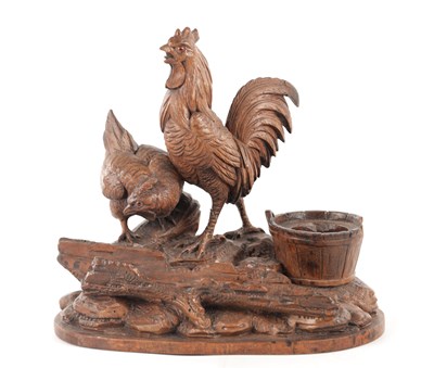Lot 1089 - A 19TH CENTURY BLACK FOREST CARVED LINDEN WOOD DESK STAND