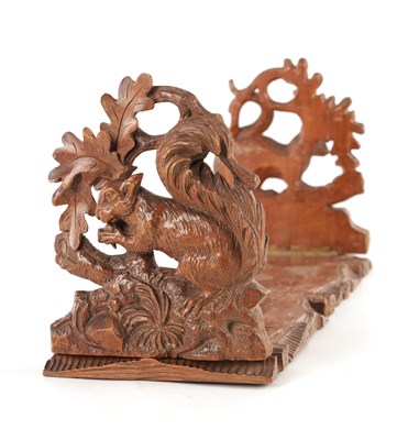 Lot 1157 - A 19TH CENTURY BLACK FOREST CARVED LINDEN WOOD PORTABLE BOOKREST
