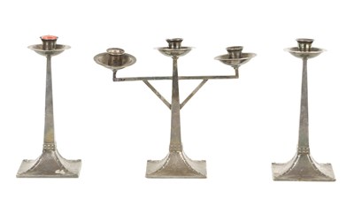 Lot 763 - A SET OF THREE ARTS AND CRAFTS CORNISH PEWTER CANDELABRA TABLE SET IN THE LIBERTY STYLE