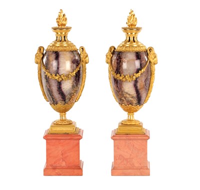Lot 834 - A FINE PAIR OF LATE GEORGE III ORMOLU AND BLUE JOHN MANTEL URNS/CANDLE HOLDERS ON VEINED PINK MARBLE PEDESTAL BASES ATTRIBUTED TO MATTHEW BOULTON
