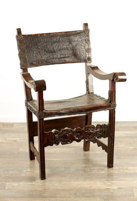 Lot 1204 - A 17TH CENTURY WALNUT AND LEATHER COVERED SPANISH ARMCHAIR