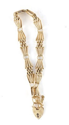 Lot 543 - A 9CT GOLD STARBURST LINK BRACELET WITH LOCKET CLASP