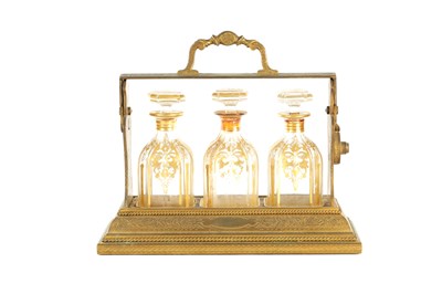 Lot 901 - A GOOD 19TH CENTURY ORMOLU ENGRAVED THREE BOTTLE TANTALUS BY BETJEMANN & SONS LONDON