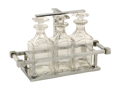 Lot 880 - A STYLISH ART DECO CHROMIUM PLATED THREE BOTTLE TANTALUS BY JACQUES ADNET