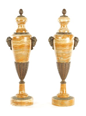Lot 921 - A PAIR OF EARLY 20TH CENTURY VEINED MARBLE AND BRONZE MOUNTED URNS