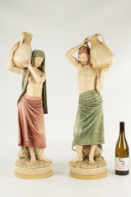 Lot 40 - A LARGE PAIR OF ROYAL DUX PORCELAIN FIGURES OF WATER CARRIERS