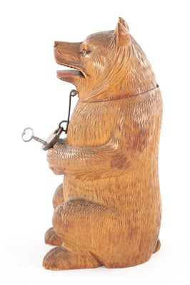Lot 1083 - AN UNUSUAL LATE 19TH CENTURY CARVED WOOD BLACK FOREST SEATED BEAR MONEY BOX