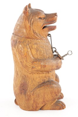 Lot 1083 - AN UNUSUAL LATE 19TH CENTURY CARVED WOOD BLACK FOREST SEATED BEAR MONEY BOX