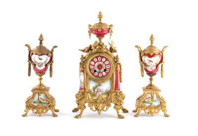 Lot 1598 - A LATE 19TH CENTURY FRENCH GILT PORCELAIN PANELLED CLOCK GARNITURE