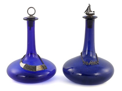 Lot 29 - A NEAR PAIR OF LATE GEORGIAN BRISTOL BLUE SHIP’S DECANTERS