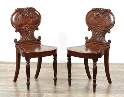 Lot 1220 - AN UNUSUAL PAIR OF REGENCY MAHOGANY HALL CHAIRS IN THE MANNER OF GILLOWS