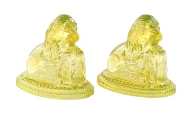 Lot 14 - A PAIR OF HENRY GREENER YELLOW PRESSED GLASS SCULPTURES OF SEATED LIONS