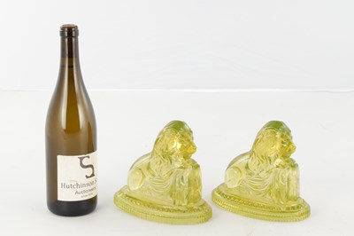 Lot 14 - A PAIR OF HENRY GREENER YELLOW PRESSED GLASS SCULPTURES OF SEATED LIONS