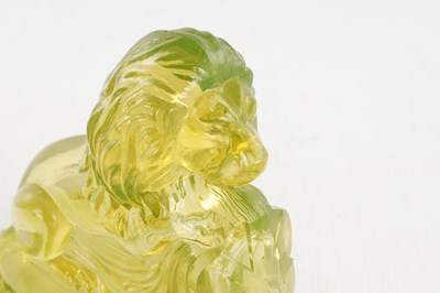 Lot 14 - A PAIR OF HENRY GREENER YELLOW PRESSED GLASS SCULPTURES OF SEATED LIONS