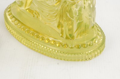 Lot 14 - A PAIR OF HENRY GREENER YELLOW PRESSED GLASS SCULPTURES OF SEATED LIONS