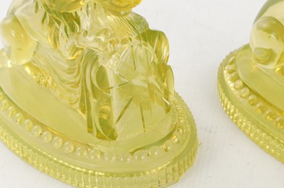 Lot 14 - A PAIR OF HENRY GREENER YELLOW PRESSED GLASS SCULPTURES OF SEATED LIONS