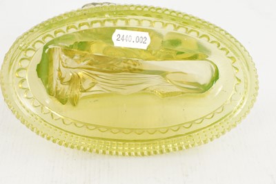 Lot 14 - A PAIR OF HENRY GREENER YELLOW PRESSED GLASS SCULPTURES OF SEATED LIONS