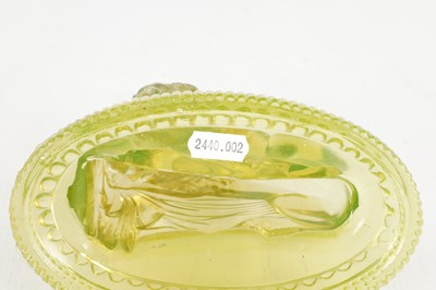 Lot 14 - A PAIR OF HENRY GREENER YELLOW PRESSED GLASS SCULPTURES OF SEATED LIONS